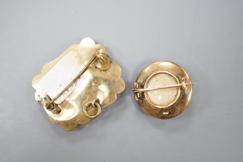 A Victorian yellow metal overlaid and blue enamel set mourning brooch, 31mm and one other seed pearl set mourning brooch.